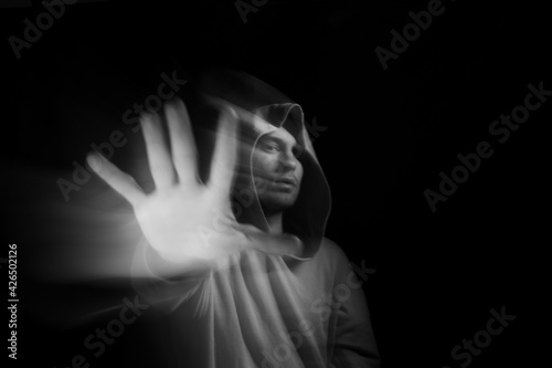 Facial face of a man in the dark. Art photography. Black-white art picture with a man. Portrait of man with blurred motion