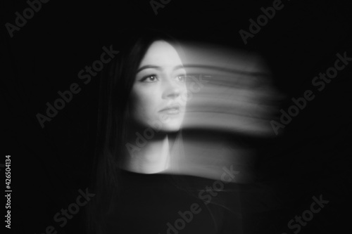 Blurred female portrait in the dark.