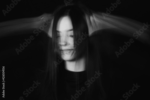 Blurred female portrait in the dark.