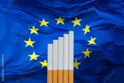 Growth in cigarette sales in Europe. Cigarettes on the background of the EU flag