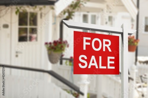 Real estate sign in front of new house for sale