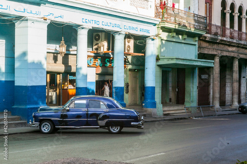 Cuban Arab Cultural Center with a vintage mid-century navy blue car parked in front of it, Havana, Cuba