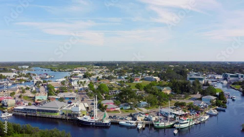 Flying Over Boats Docked on Bay and Towards a Commercial Neighborhood in Florida photo