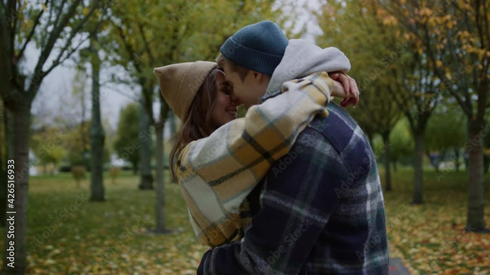 Beautiful young lovers kissing romantically in autumn park. Close up of couple. Beautiful young lovers kissing romantically in autumn park. Close up of couple.