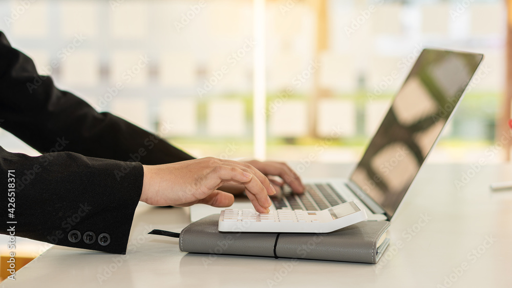 Accountants work with computers and calculators in the office. Stock