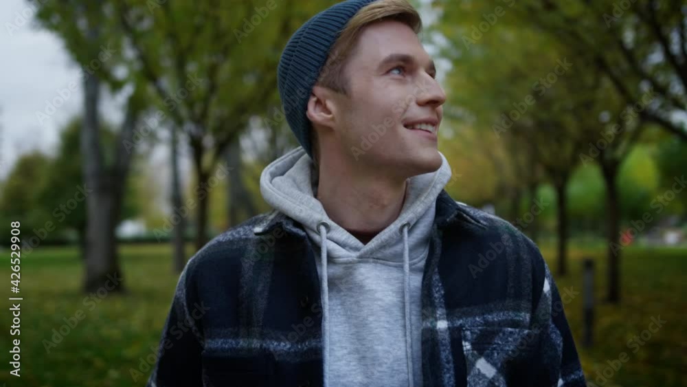 Portrait of handsome young man looking around beautiful autumn park . Portrait of handsome young man looking around beautiful autumn park .