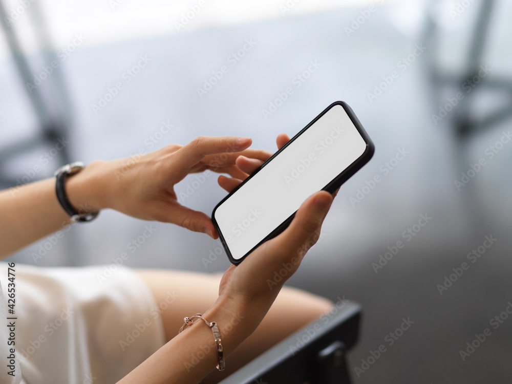 A woman using smartphone include clipping path screen in her hands