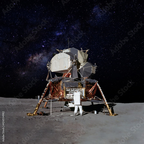 Astronaut on moon (lunar) landing mission with earth on the background. Elements of this image furnished by NASA. photo