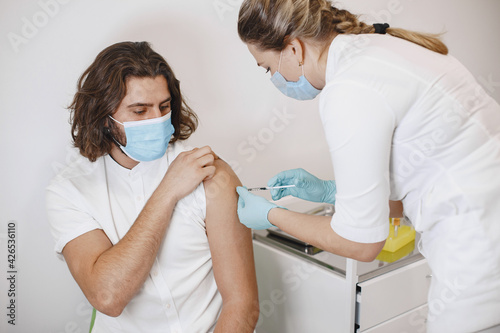 Woman doctor gives a vaccine to patients