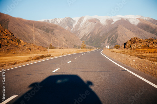 Wallpaper Mural Chuya tract road with shadow of car with snow peaks of Altay Mountain on background Torontodigital.ca