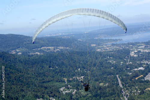 Para gliders catching the warm air up draft from Poo Poo Point to stay airborne. 
