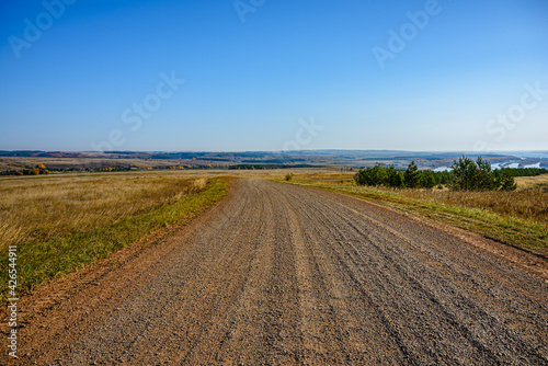 The dirt road goes into the distance to the big Kama river