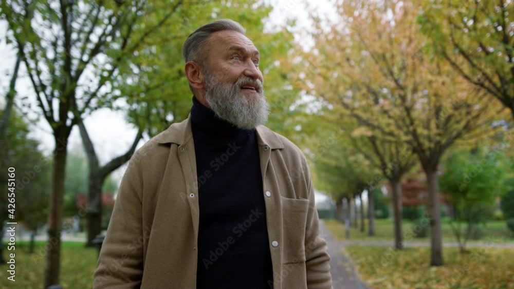Portrait of happy smiling attractive mature man looking around autumn park. Portrait of happy smiling attractive mature man looking around autumn park.