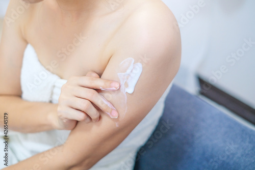 Woman applying natural cream  Woman moisturizing her arm with cosmetic cream  Spa and Manicure concept.