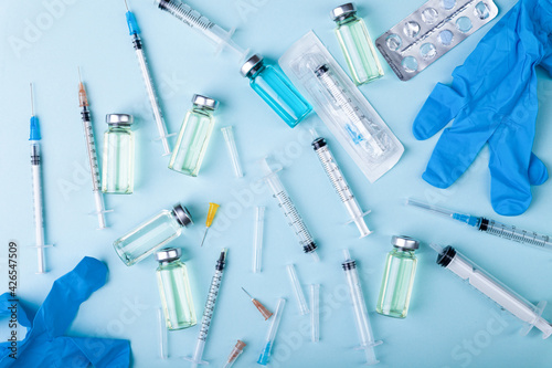 Glass vaccine ampoules, bottles, gloves, syringes, needles, pills