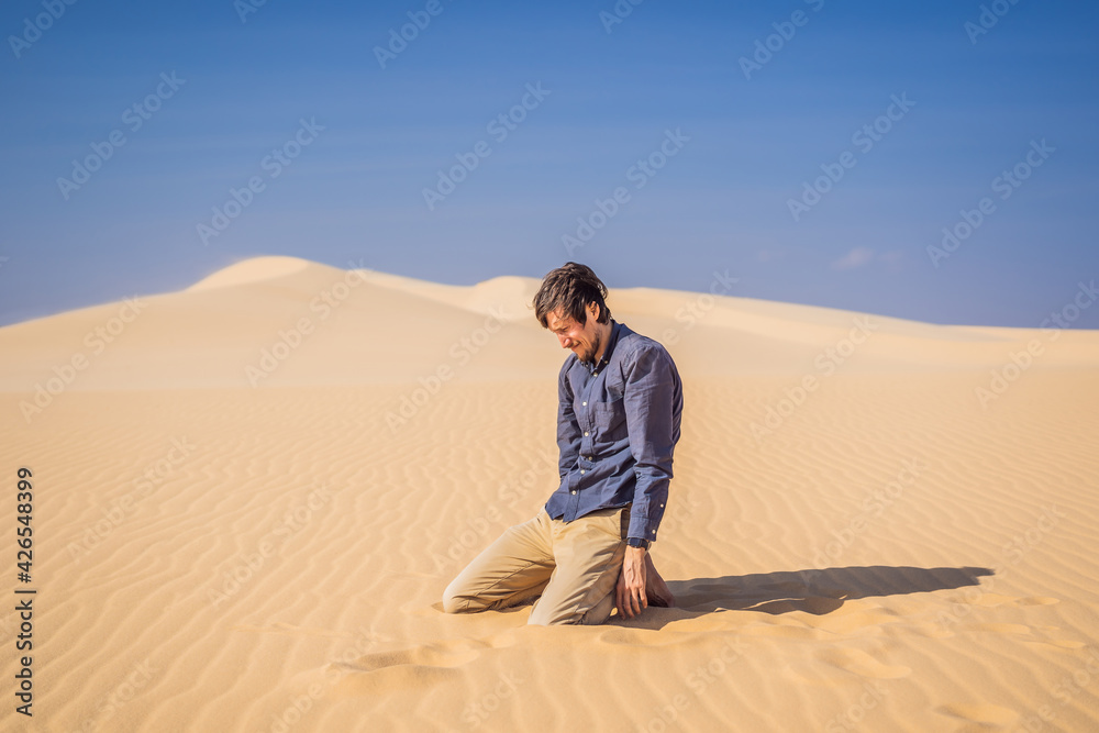 Exhausted man in the desert. Apathy, fatigue, exhaustion, mental disorders concept. Mental health