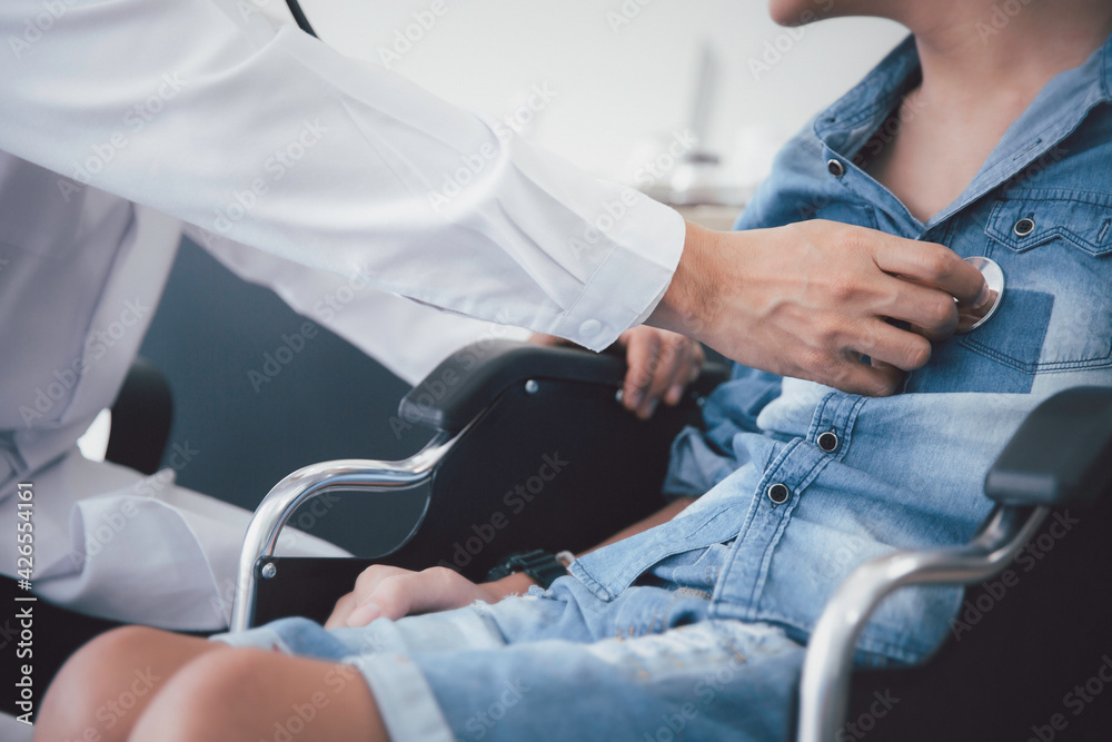 Asian doctor use stethoscope checkup  disability wheel chair patient  person