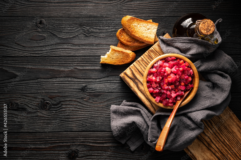 vegetable salad and toasted bread on wooden background top view, copy space vegetable salad and toasted bread on wooden background top view, copy space