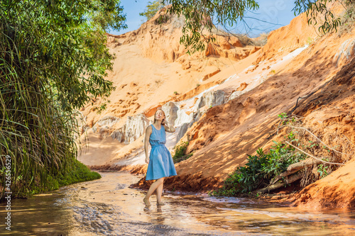 Woman tourist on the Fairy stream among the red dunes, Muine, Vietnam. Vietnam opens borders after quarantine COVID 19