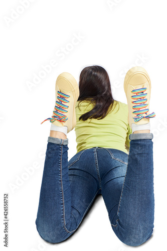 Woman lying on the floor with sneakers laced with rainbow LGBT flag