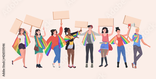 gays and lesbians with lgbt rainbow flags holding protest posters blank placards love parade pride festival demonstration concept full length horizontal