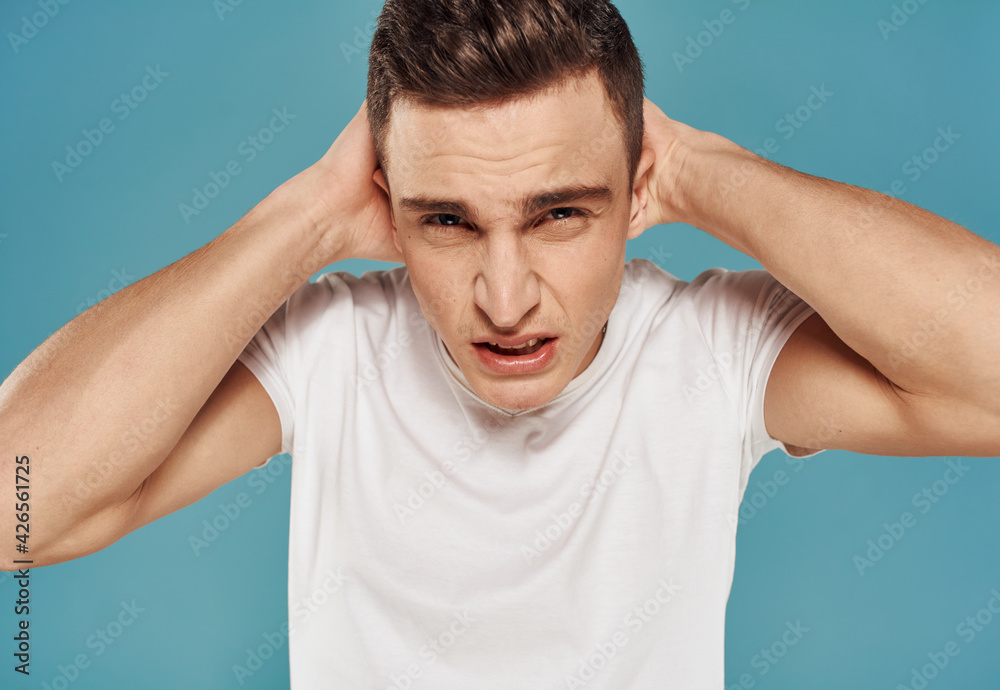 Man in white t-shirt cropped view of emotion displeasure studio Man in white t-shirt cropped view of emotion displeasure studio