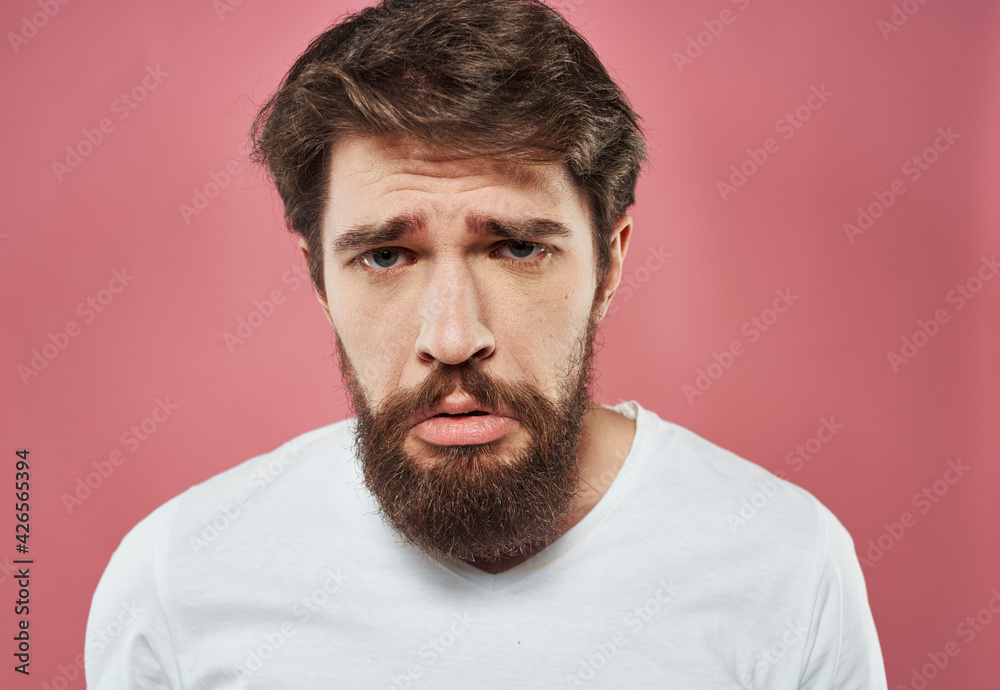Upset car on a pink background portrait close-up puzzled look