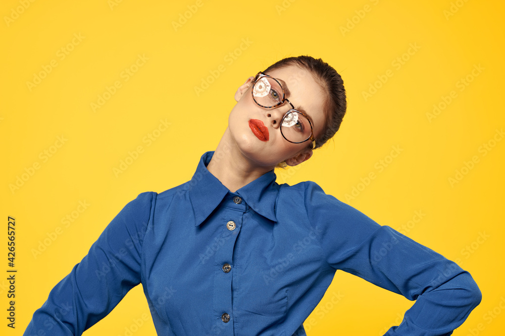 Fototapeta premium Cheerful woman elegant style glasses smile red lips yellow background