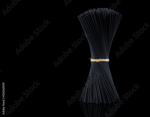 Bouquet, raw, black pasta, spaghetti, on a black background, no people, horizontal,