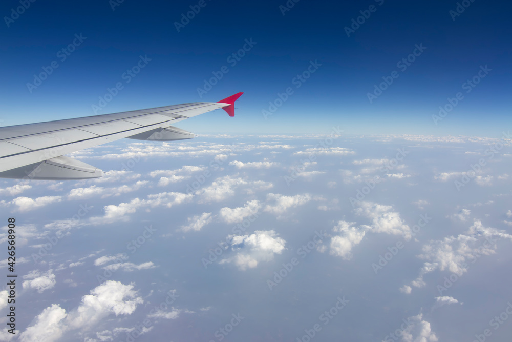 An airplane wing in the sky The sky atmosphere is cloudy and dust is thick. Fly on the Asian continent, Thailand. An airplane wing in the sky The sky atmosphere is cloudy and dust is thick. Fly on the Asian continent, Thailand.