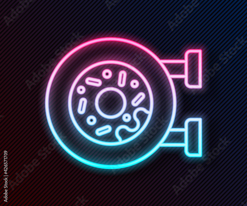 Glowing neon line Donut with sweet glaze icon isolated on black background. Vector