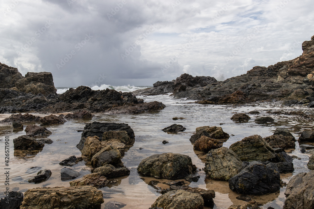 Cloudy view of rocky beach coastline at Port Macquarie, Australia.