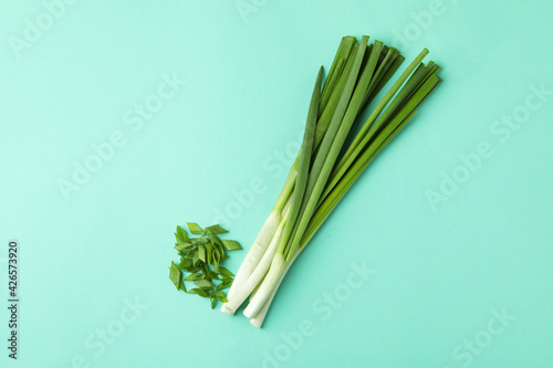 Bunch of green onion on mint background