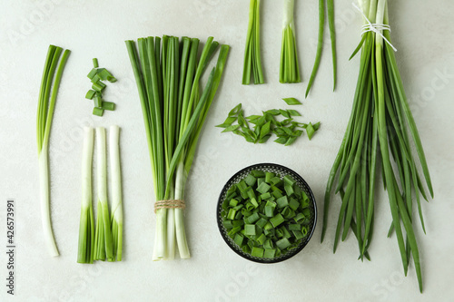 Fresh green onion on white textured background