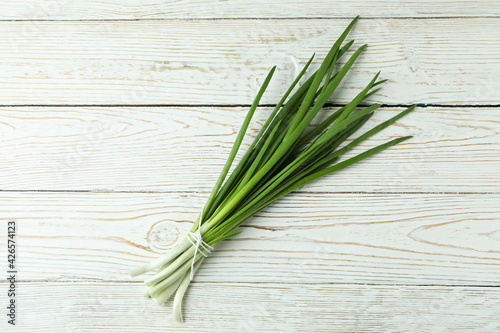 Fresh green onion on white wooden background