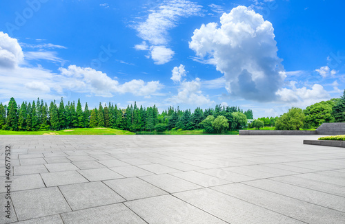 Wide square floor and green trees in natural park.