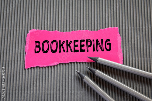 Bookkeeping. Note sheet and pencils on a gray background photo