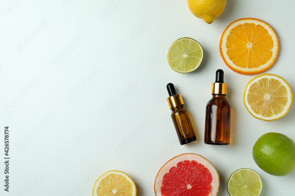 Dropper bottles with oil and citrus on white background Dropper bottles with oil and citrus on white background