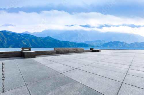 Empty square floor and mountain with lake landscape under the blue sky.