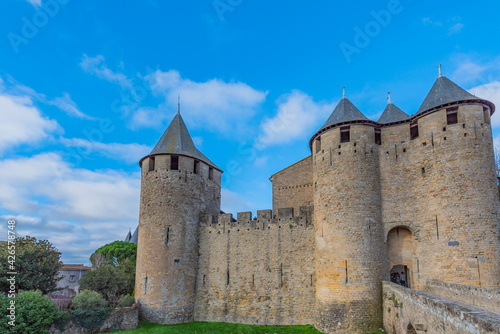 View to the entrance with the bridge from left and the tower, historical castle carcassone - cite de carcassone at morning
