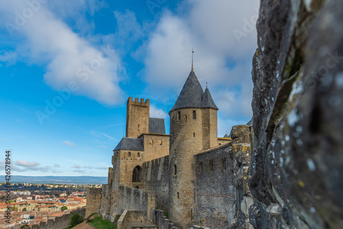 View over the historical castle carcassone - cite de carcassone - with the towers, background blue sky, close up to the wall
