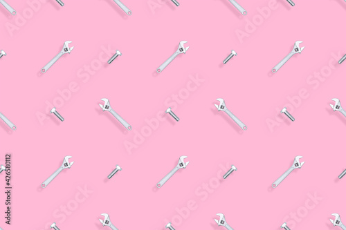 Adjustable metal wrench seamless pattern. Background from a metal wrench and a bolt.  © Zuev Ali