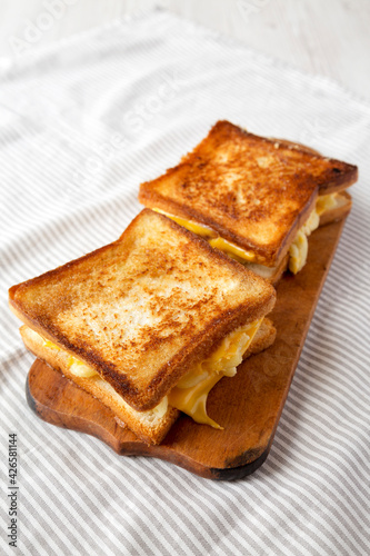 Homemade Grilled Macaroni and Cheese Sandwich on a rustic wooden board, low angle view. Copy space.