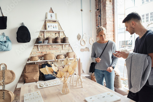 Female and male customers standing in store