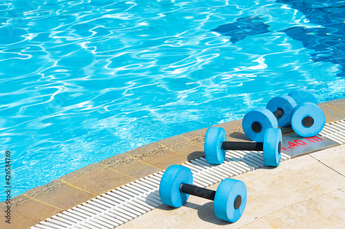 Canvas Print dumbbells equipment for aqua aerobics sport near swimming pool