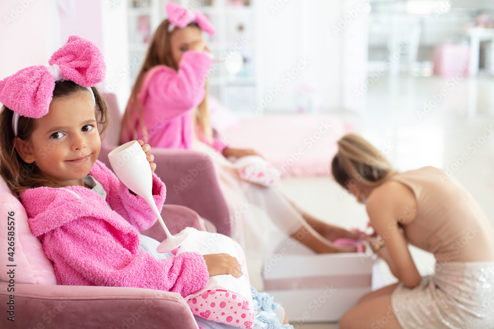 Children in spa center having a manicure and pedicure.