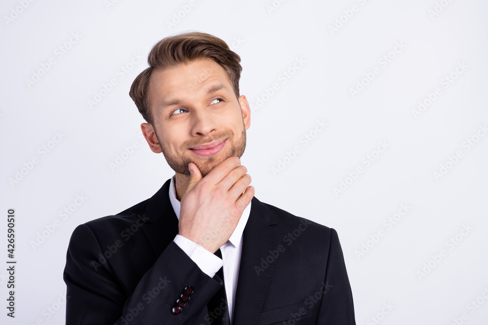 Photo portrait of smiling curious businessman in blazer looking blank space got idea isolated on white color background Photo portrait of smiling curious businessman in blazer looking blank space got idea isolated on white color background