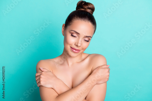Portrait of attractive trendy girl hugging herself scrub clean perfect skin wash bath isolated over bright teal turquoise color background