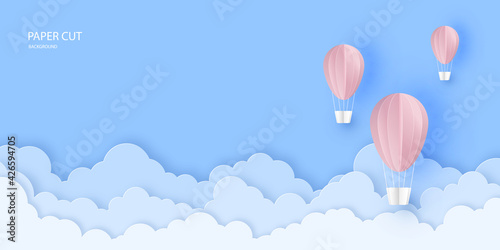 Pink beautiful hot air balloons flying over clouds in the sky.