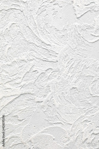 Vertical background and texture of decorative plaster to cover the walls and ceilings. White background for design and decoration. Copy space